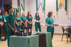 Senior PSU nursing students giving out stethoscopes to their junior-year colleagues