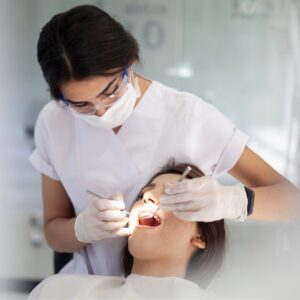 A dental hygienist caring for a patient