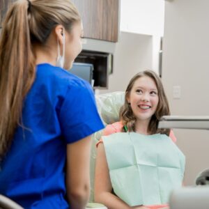 a dental hygienist talking to a patient