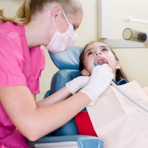 Dental hygienist working with a patient