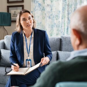 A social worker on a couch talking to a patient