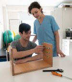 An occupational therapist working with a patient